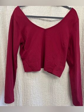 Lululemon women’s cropped Long Sleeve align shirt color is called pomegranate